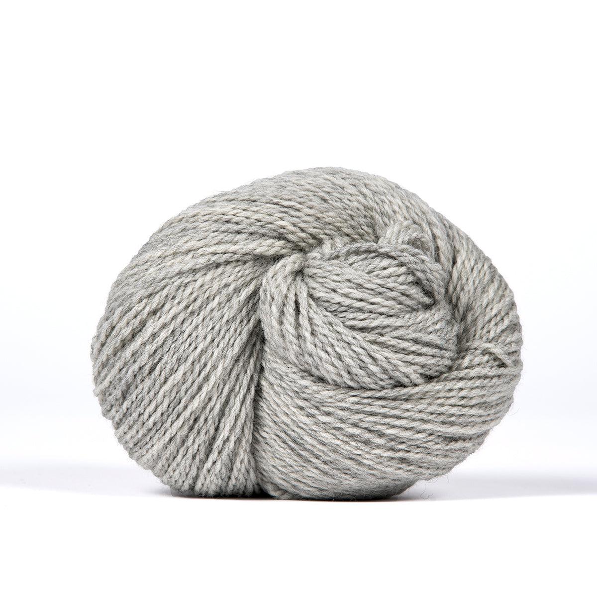 A skein of Kelbourne Woolens Camper Gray Heather 058, a heathered light grey.