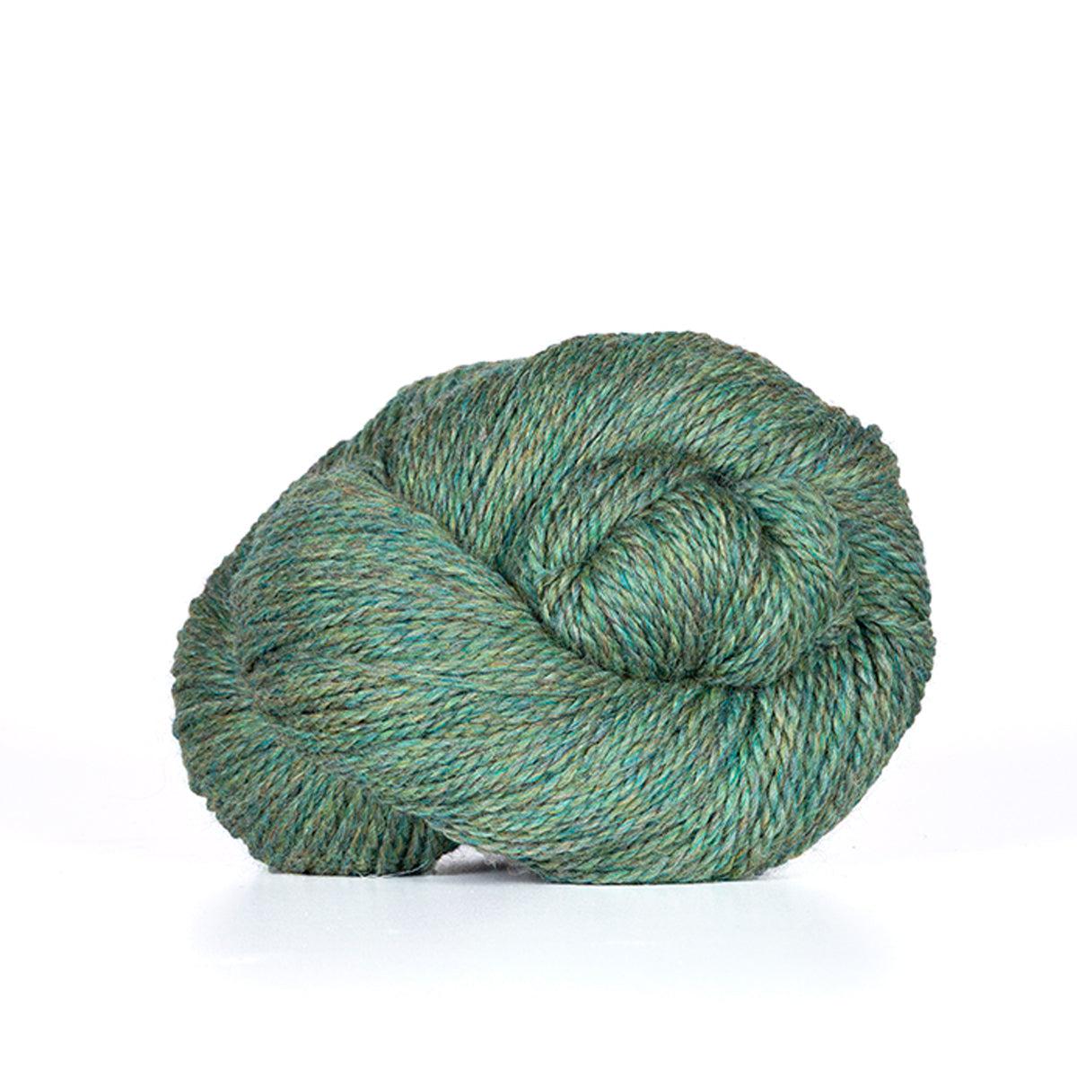 A skein of Kelbourne Woolens Camper Meadow Heather 330, a heathered jade green.