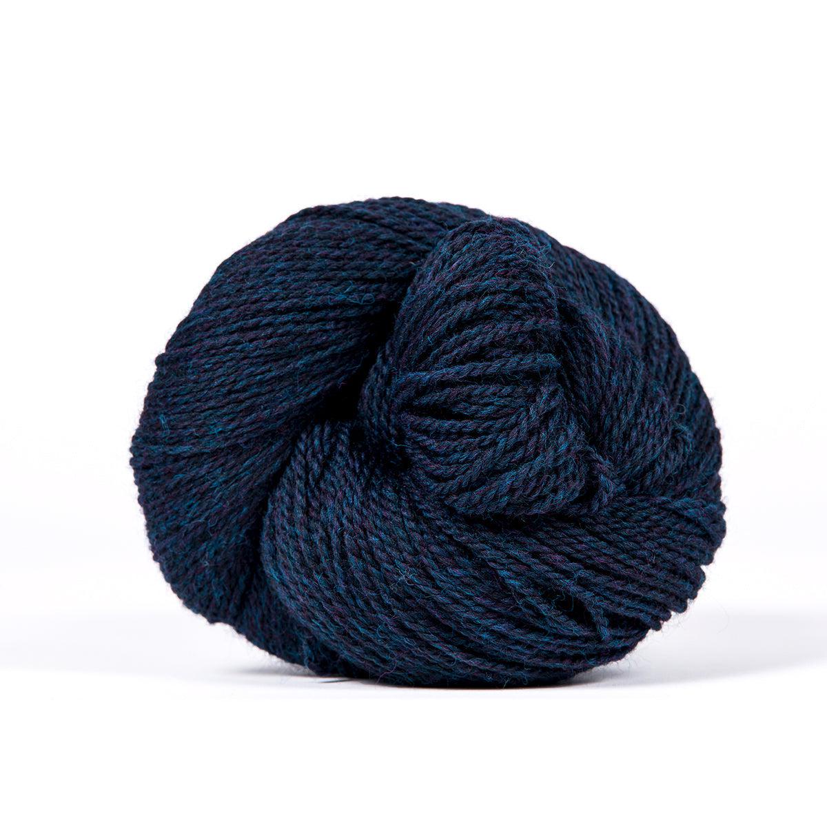 A skein of Kelbourne Woolens Camper Navy Heather 412, a heathered dark blue.