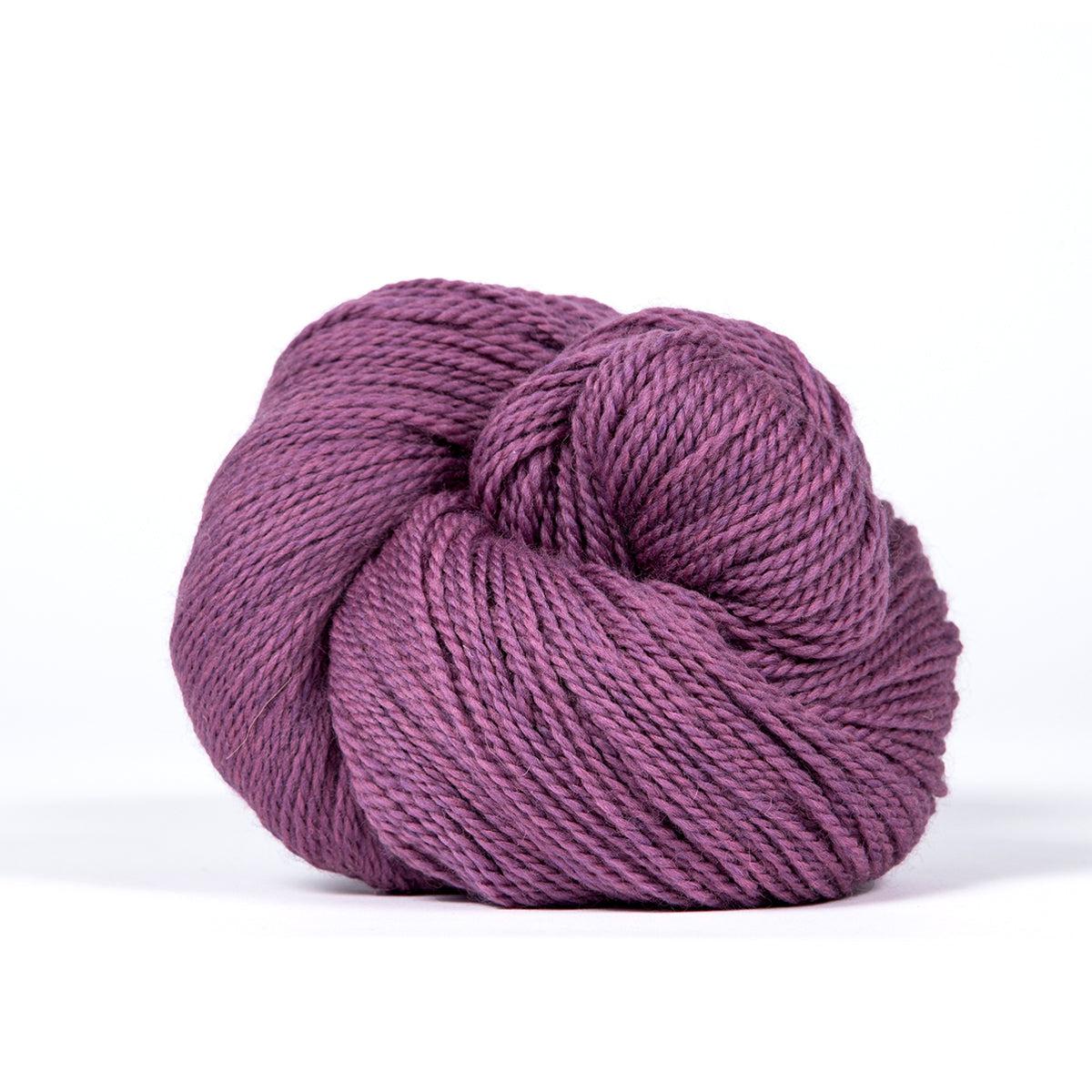 A skein of Kelbourne Woolens Camper Orchid Heather 519, a heathered medium pink purple.