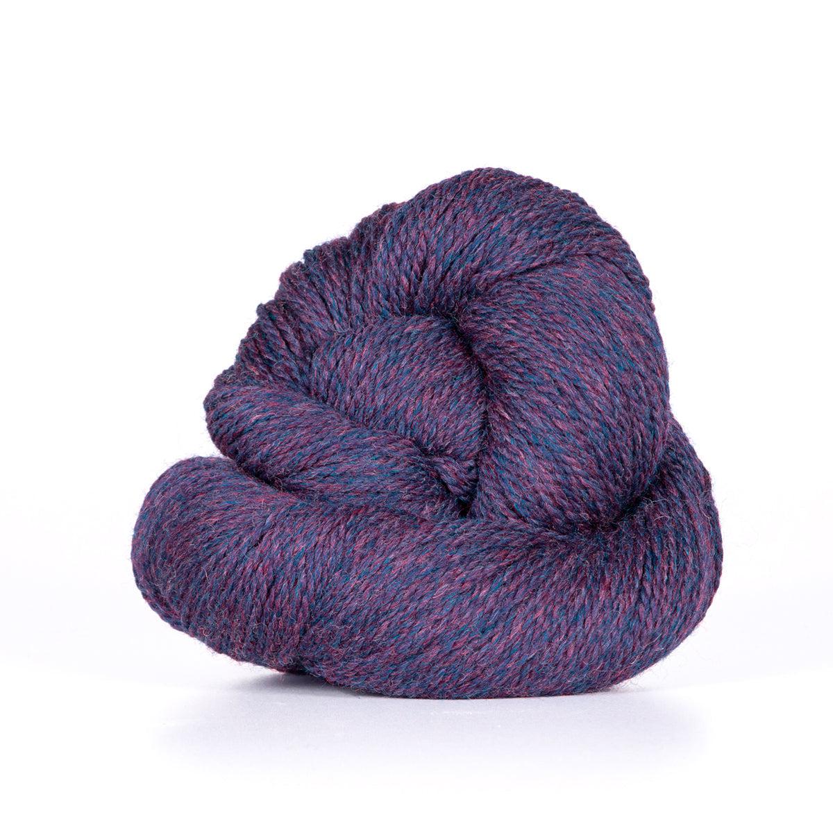 A skein of Kelbourne Woolens Camper Plum Heather 501, a heathered purple.