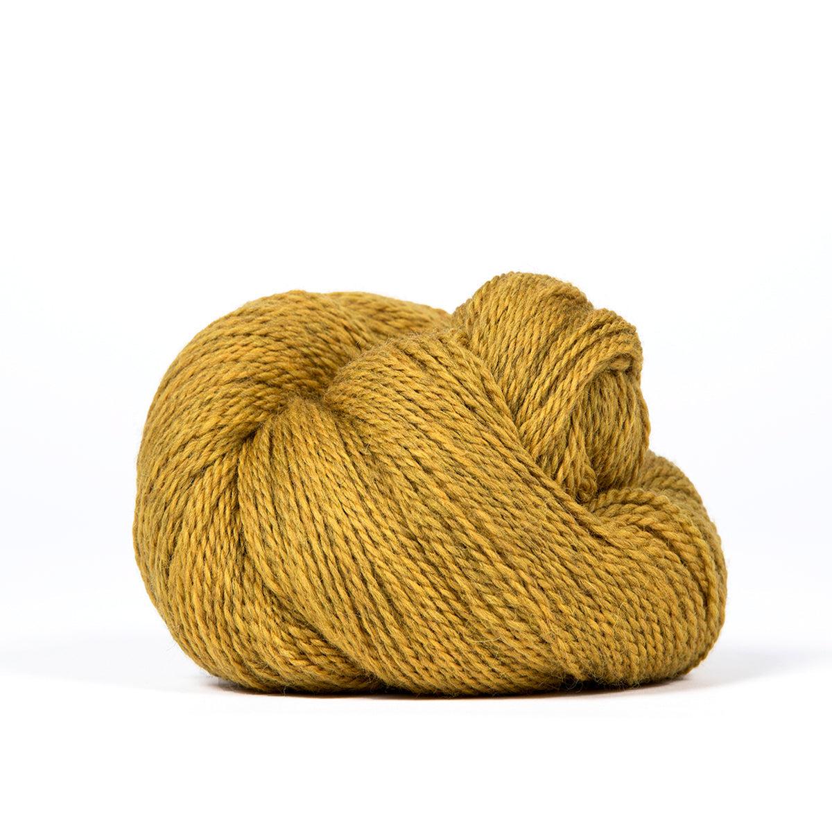 A skein of Kelbourne Woolens Camper Sunflower Heather 709, a heathered light mustard yellow.