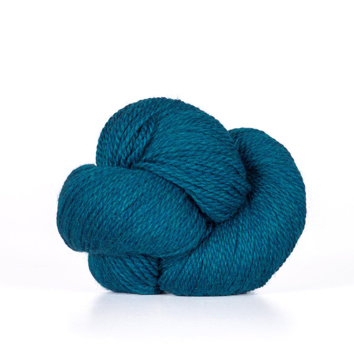 A skein of Kelbourne Woolens Camper Teal Heather 432, a heathered bright teal.