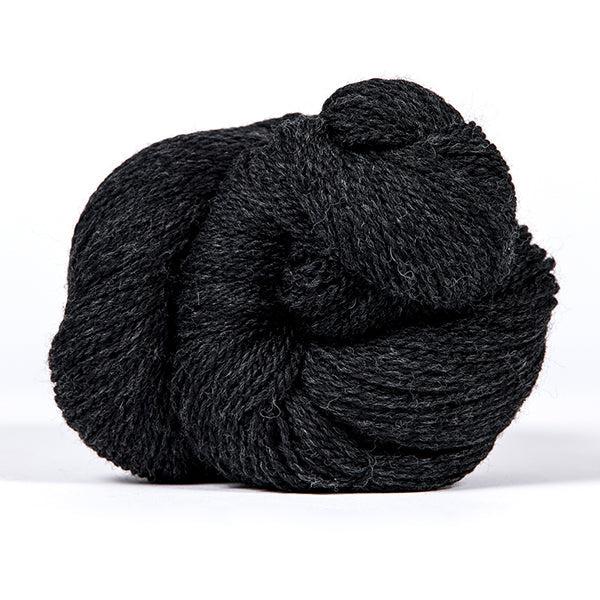 A skein of Kelbourne Woolens Scout Charcoal Heather 026, a heathered dark charcoal. 