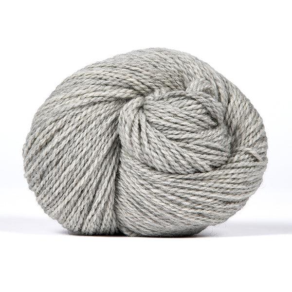 A skein of Kelbourne Woolens Scout Gray Heather 058, a heathered light grey.