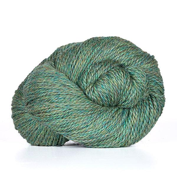A skein of Kelbourne Woolens Scout Meadow Heather 330, a heathered jade green.