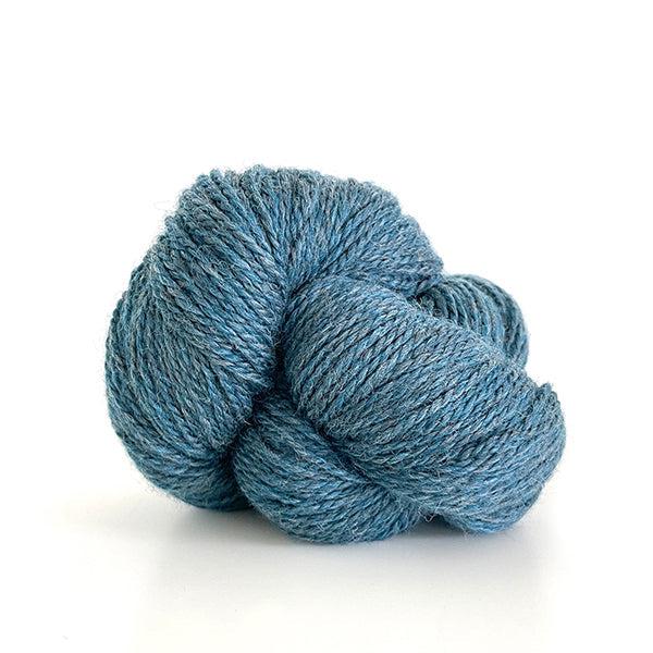 A skein of Kelbourne Woolens Scout Ocean Heather 419, a heathered light blue. 