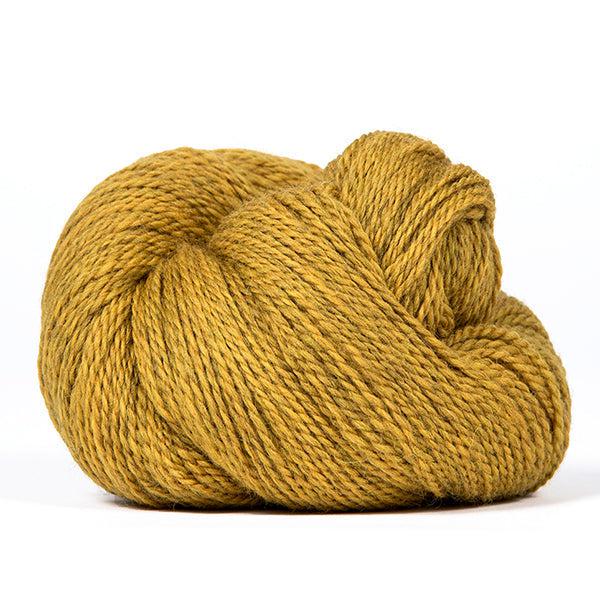 A skein of Kelbourne Woolens Scout Sunflower Heather 709, a heathered ochre yellow.