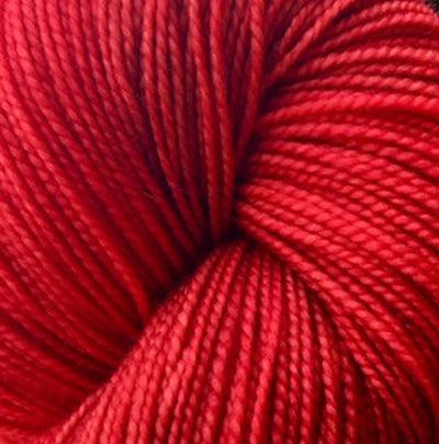 Detail of Knerd String 4ply Fingering Kiss Me Kiss Me Kiss Me a deep red color.