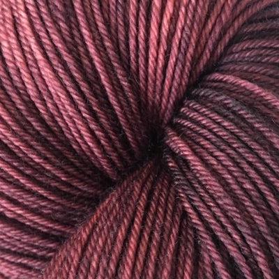 Detail of Knerd String 4ply Fingering Whattamaroon a maroon color with some darker maroon undertones.