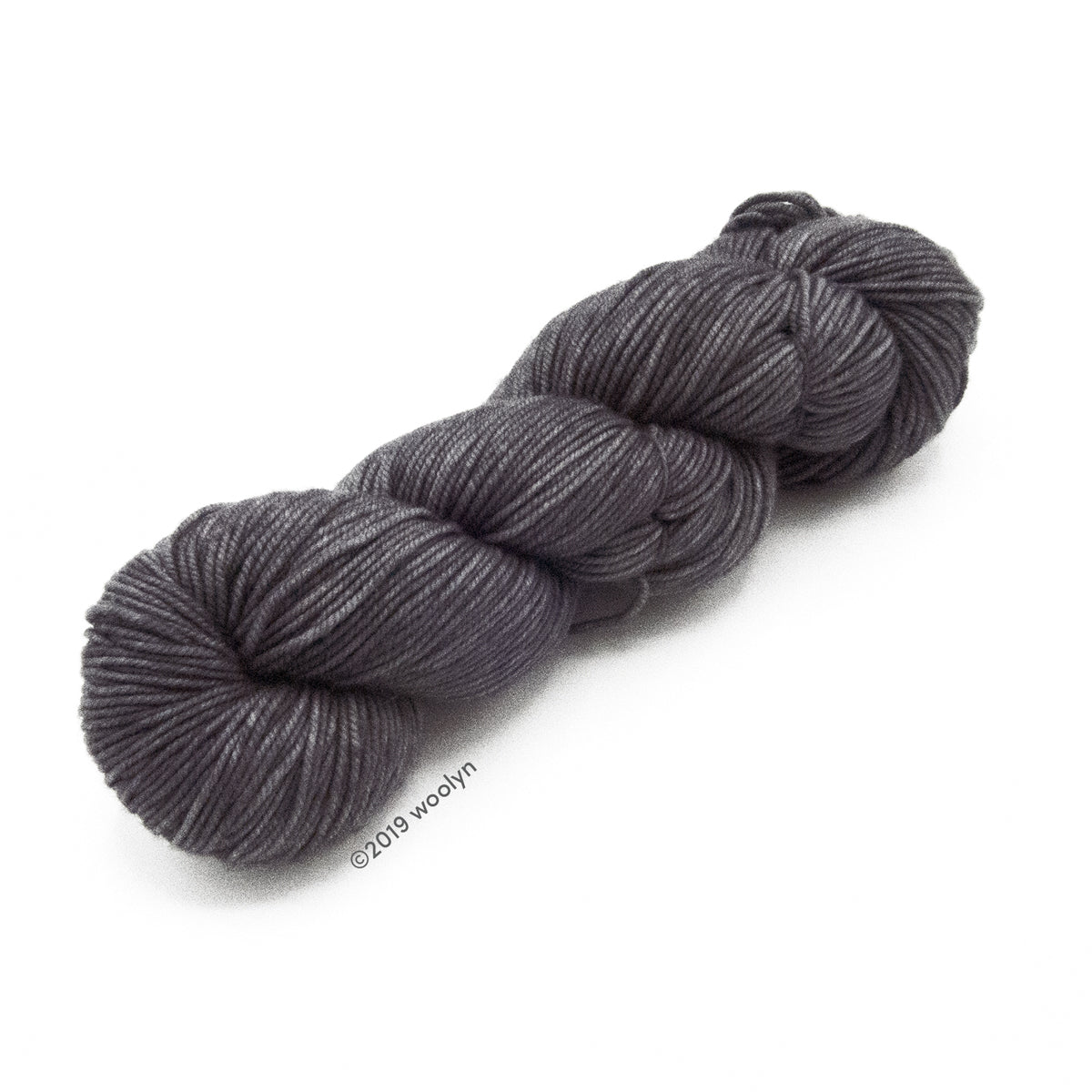 A skein of Knitted Wit Victory DK in Grey Wolf a solid medium grey color. 