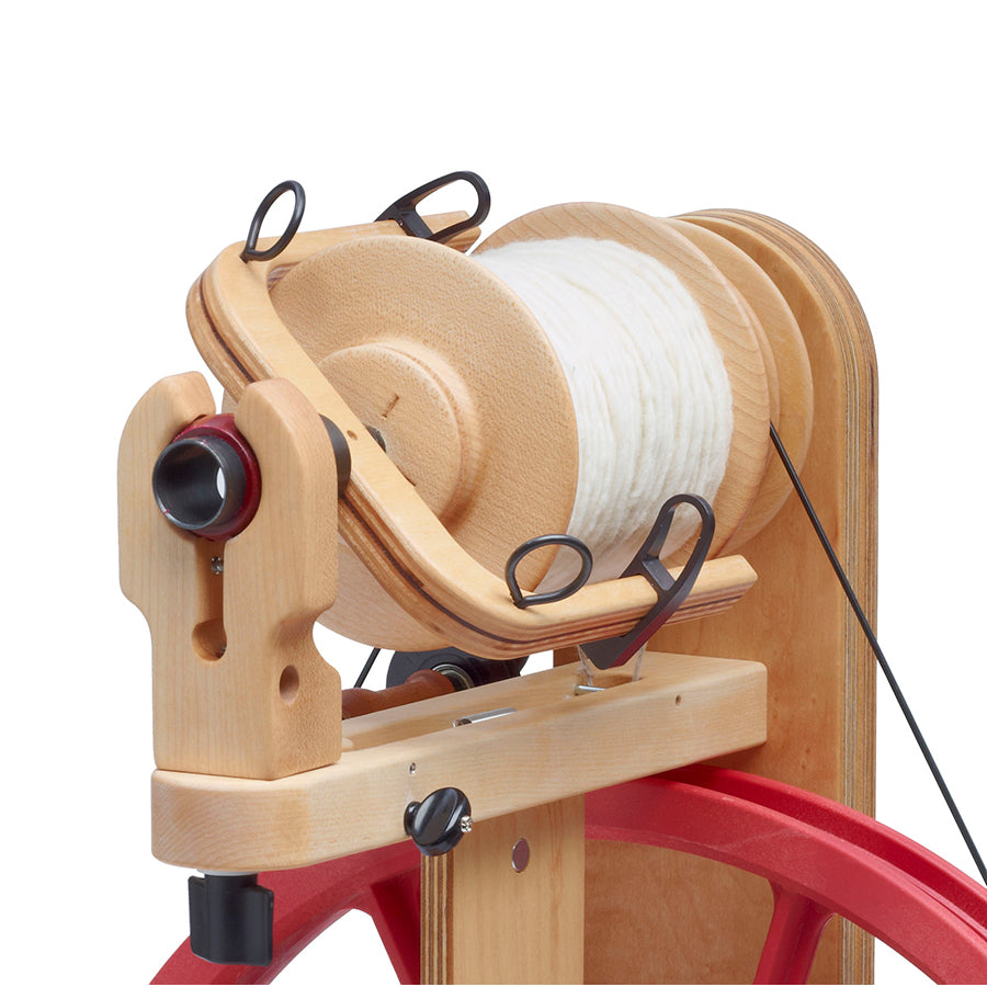 Detail image of a Schacht Ladybug Spinning Wheel with a bulky weight bobbin.