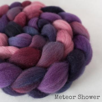Detail of Greenwood Fiberworks Pigtails Meteor Shower in purples, pinks, reds and black.