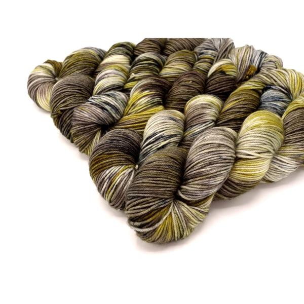 Skeins of Murky Depths Neptune DK Knight in Tarnished Armor, a variegated yarn in shades of gold, brown and cream.  