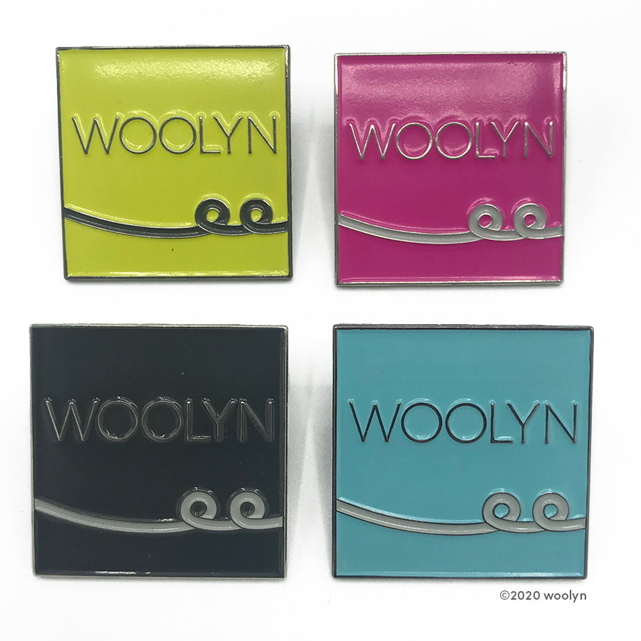Woolyn exclusive Enamel Pin in four different colors: chartruese, pink, black and turquoise.