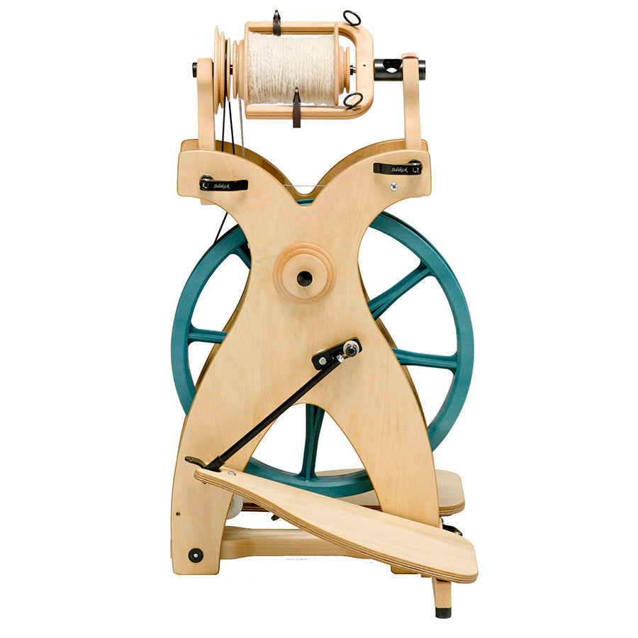 A side view of a Schacht Sidekick Spinning Wheel with a bobbin.