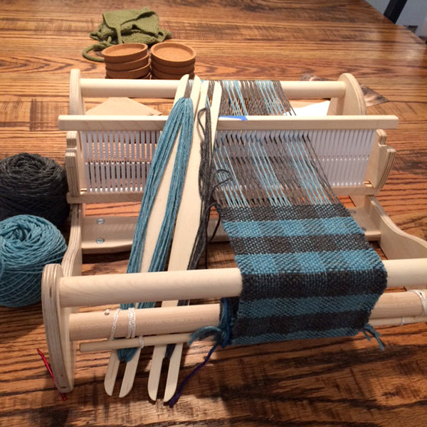 Blue and Grey checkerboard scarf being woven on a Cricket rigid heddle loom